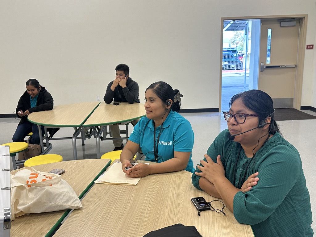 Nurbli interpreters at work with headsets